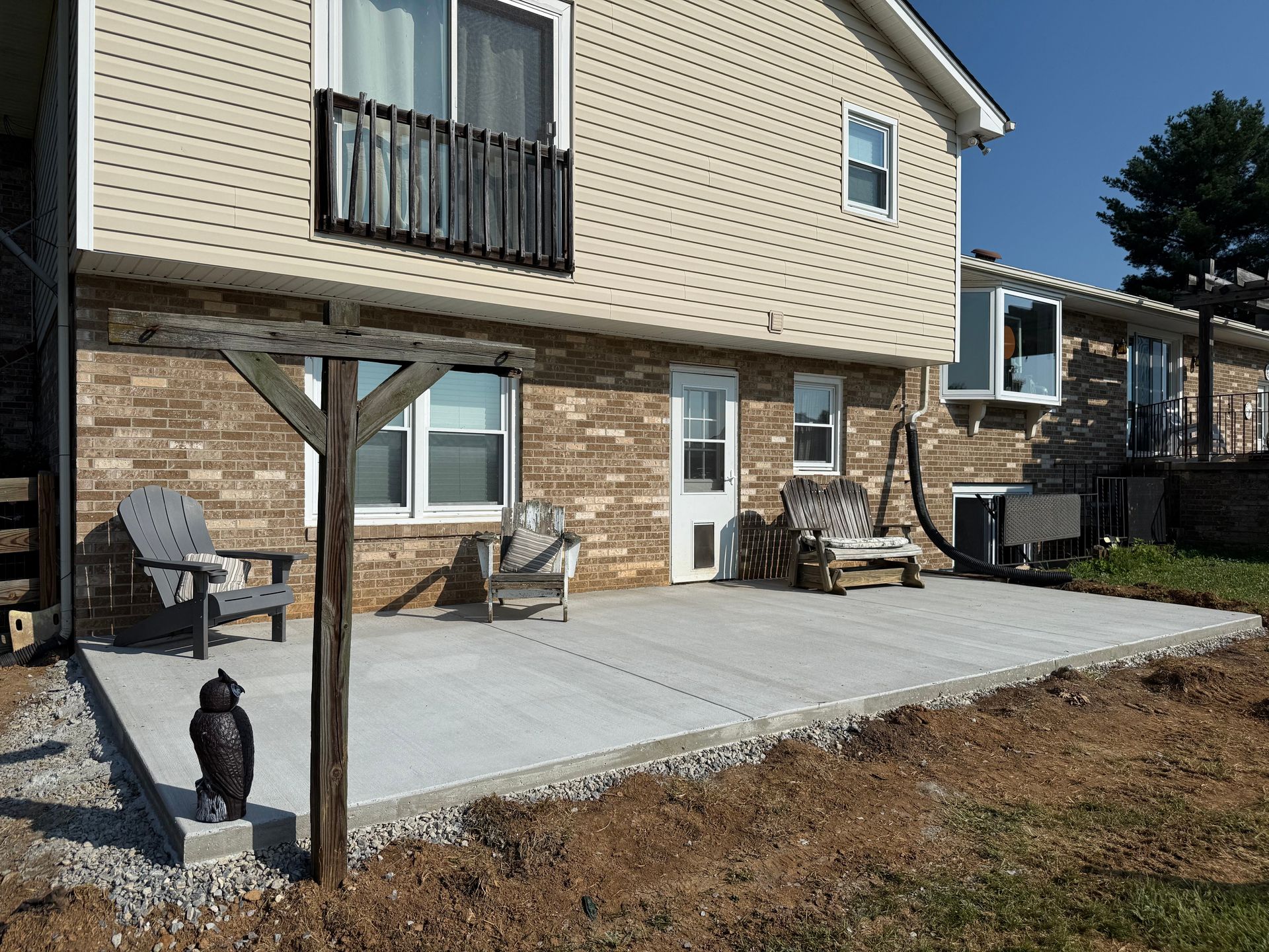 An artist 's impression of a backyard with a patio and furniture.