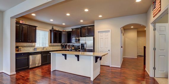 A kitchen with a large island and stainless steel appliances.