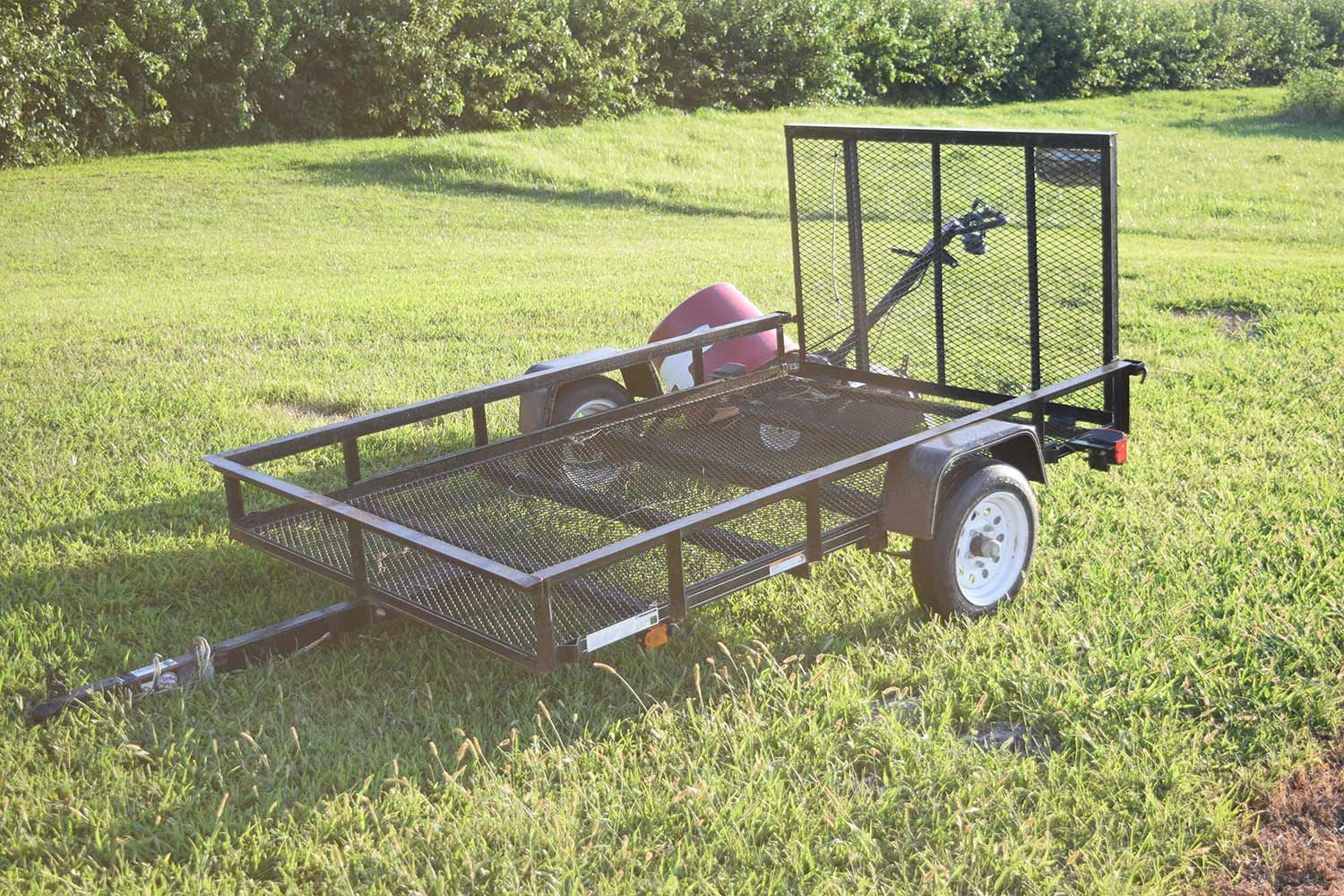 Black utility trailer on wide backyard