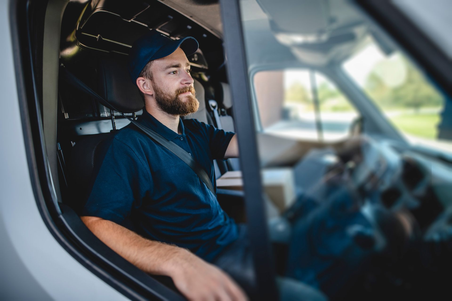 a man is sitting in the driver 's seat of a van .