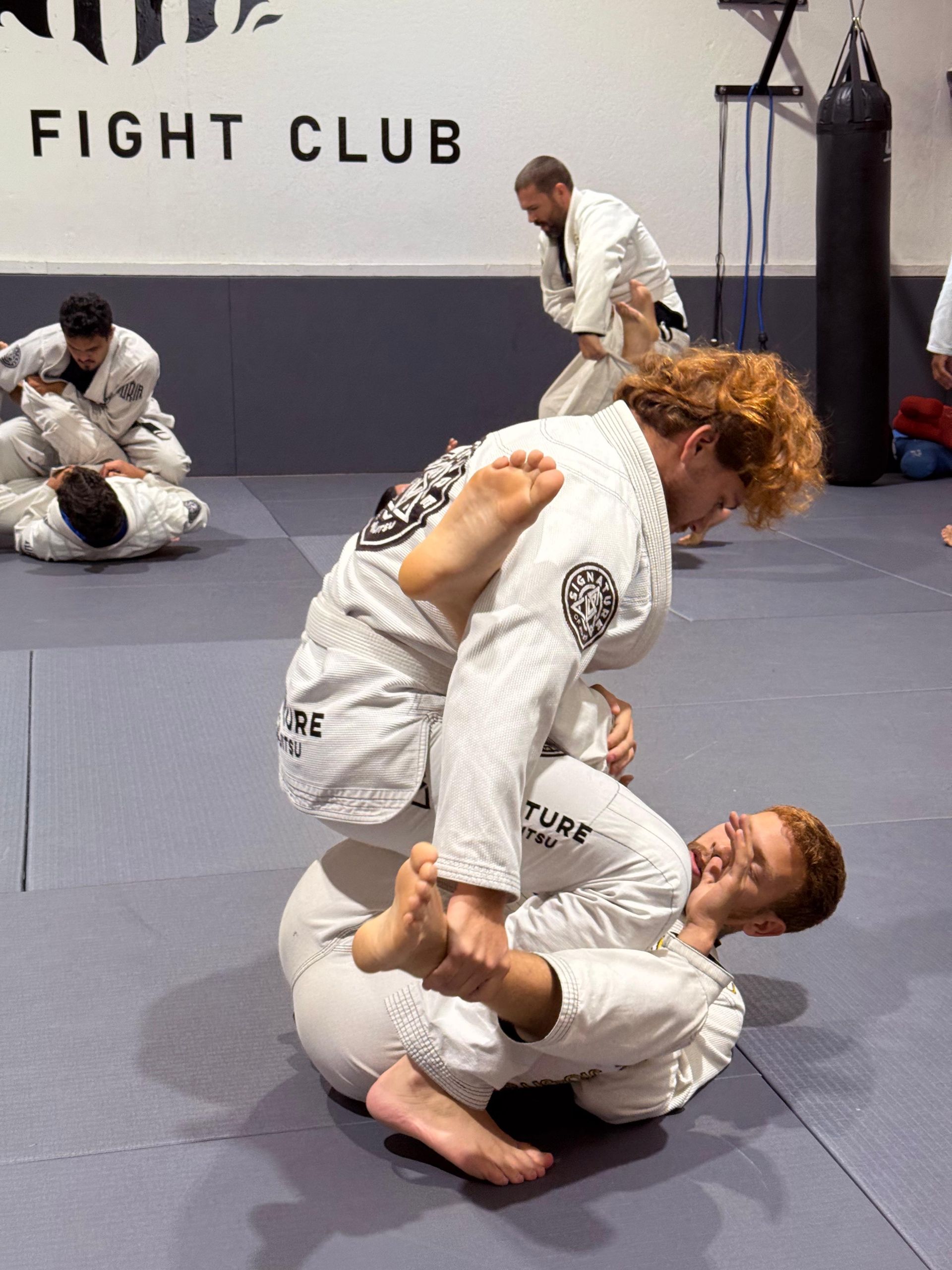 Adult students drilling jiu-jitsu technique at Signature of Jiu-Jitsu in Belmont, CA.