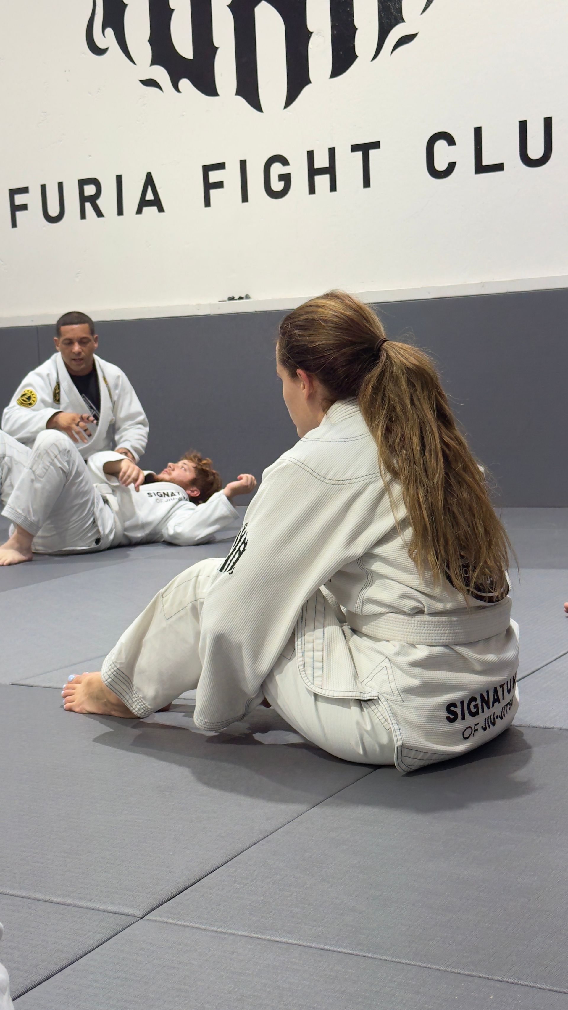 Beginner students drilling Jiu-Jitsu positions at Signature of Jiu-Jitsu in Belmont, CA for fitness and confidence. 