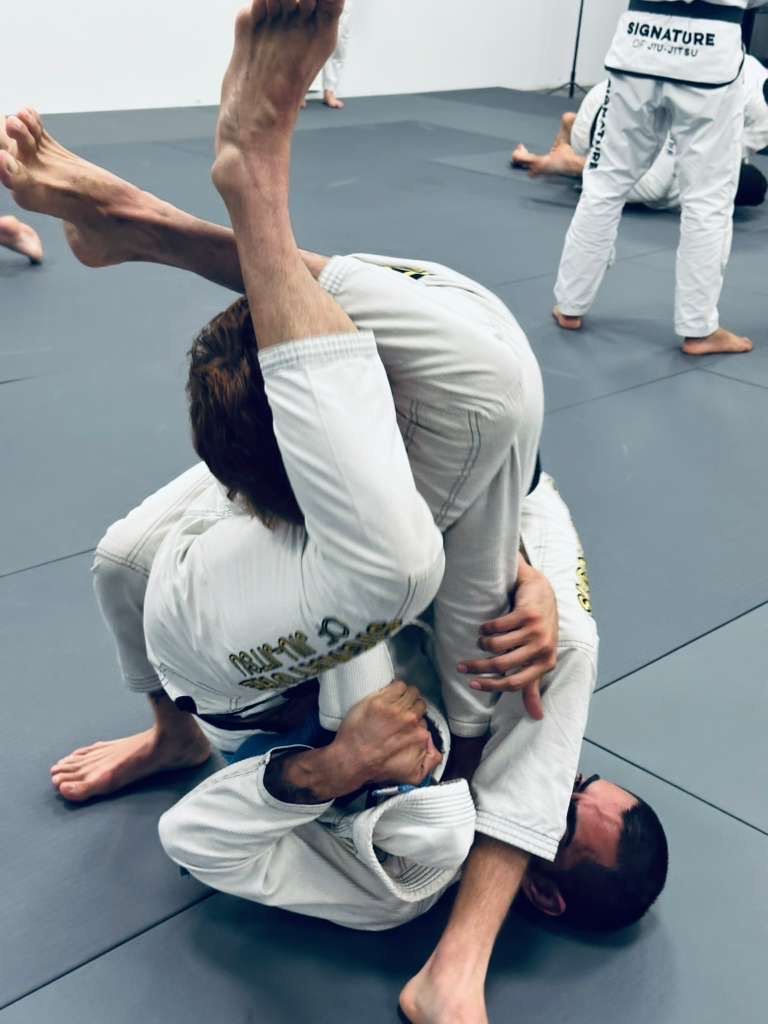 Students drilling Brazilian Jiu-Jitsu technique at Signature of Jiu-Jitsu in Belmont, CA.