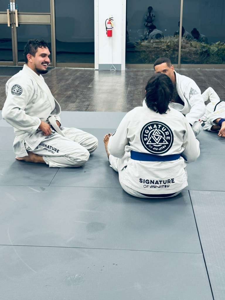 Students drilling Jiu-Jitsu techniques at Signature of Jiu-Jitsu in Belmont, CA to build calm focus.