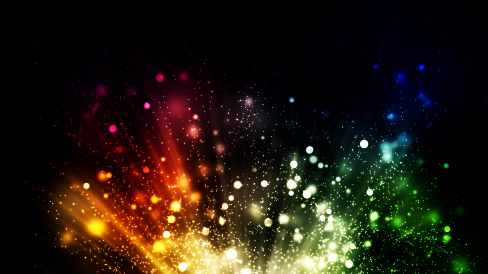 An array of colorful sparks in a rainbow of colors creates a stunning visual on a black background. 