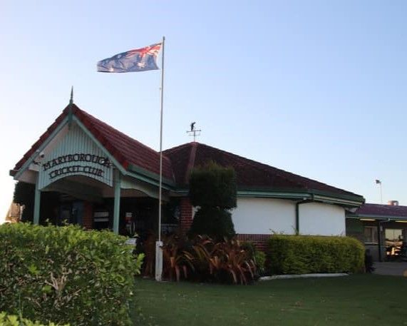 A Flag Is Flying In Front Of A Building That Says Warriors College — Maryborough Cricket Club In Maryborough, QLD
