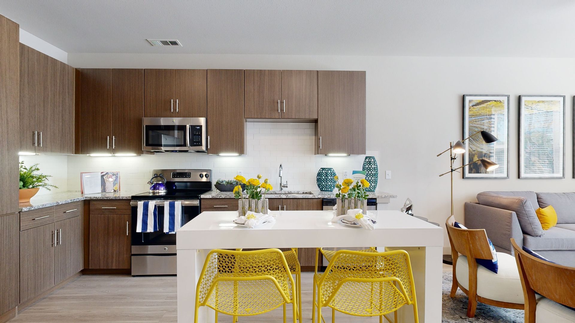 A kitchen with stainless steel appliances , wooden cabinets , and a large island.