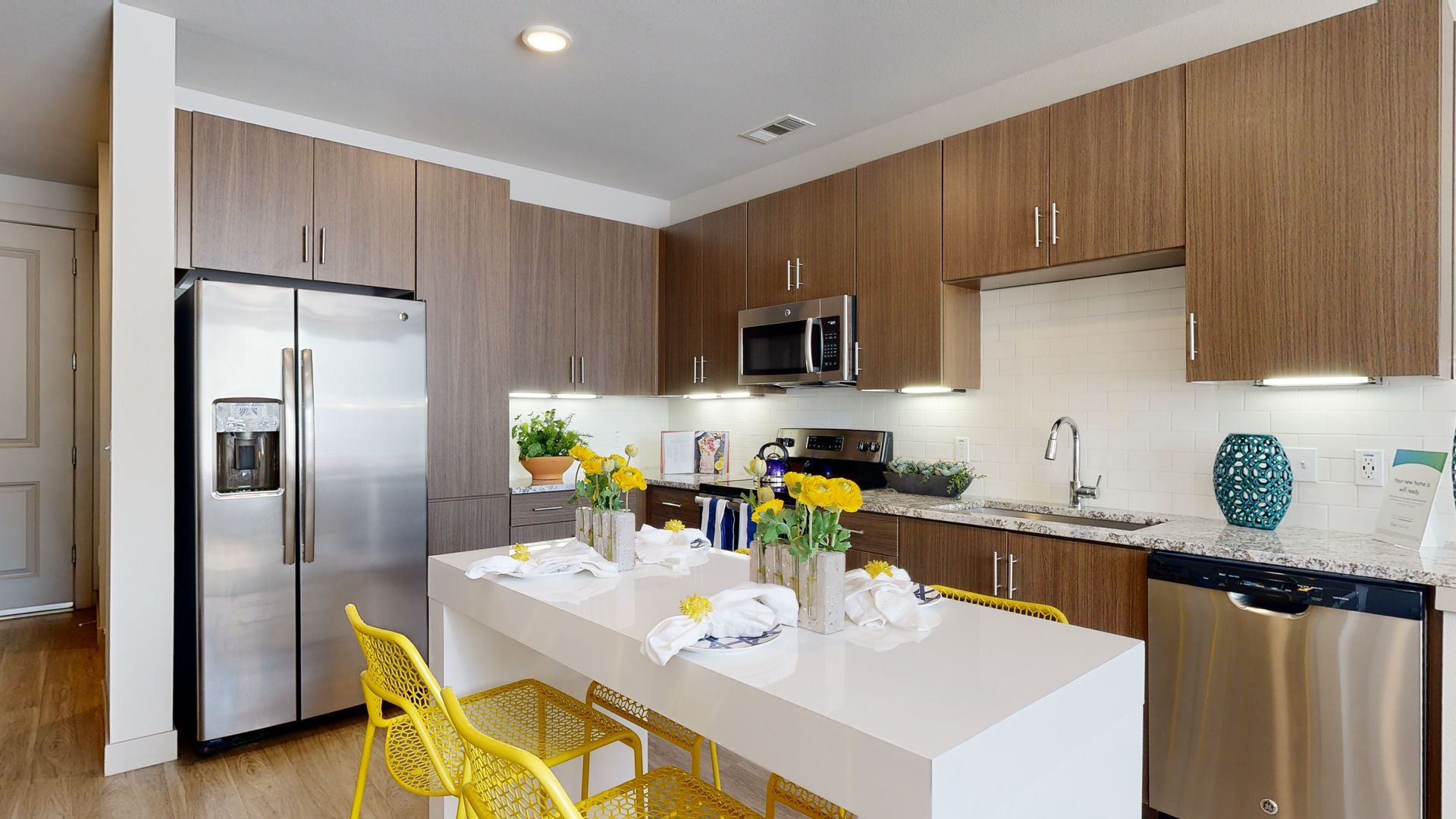 A kitchen with stainless steel appliances and wooden cabinets.