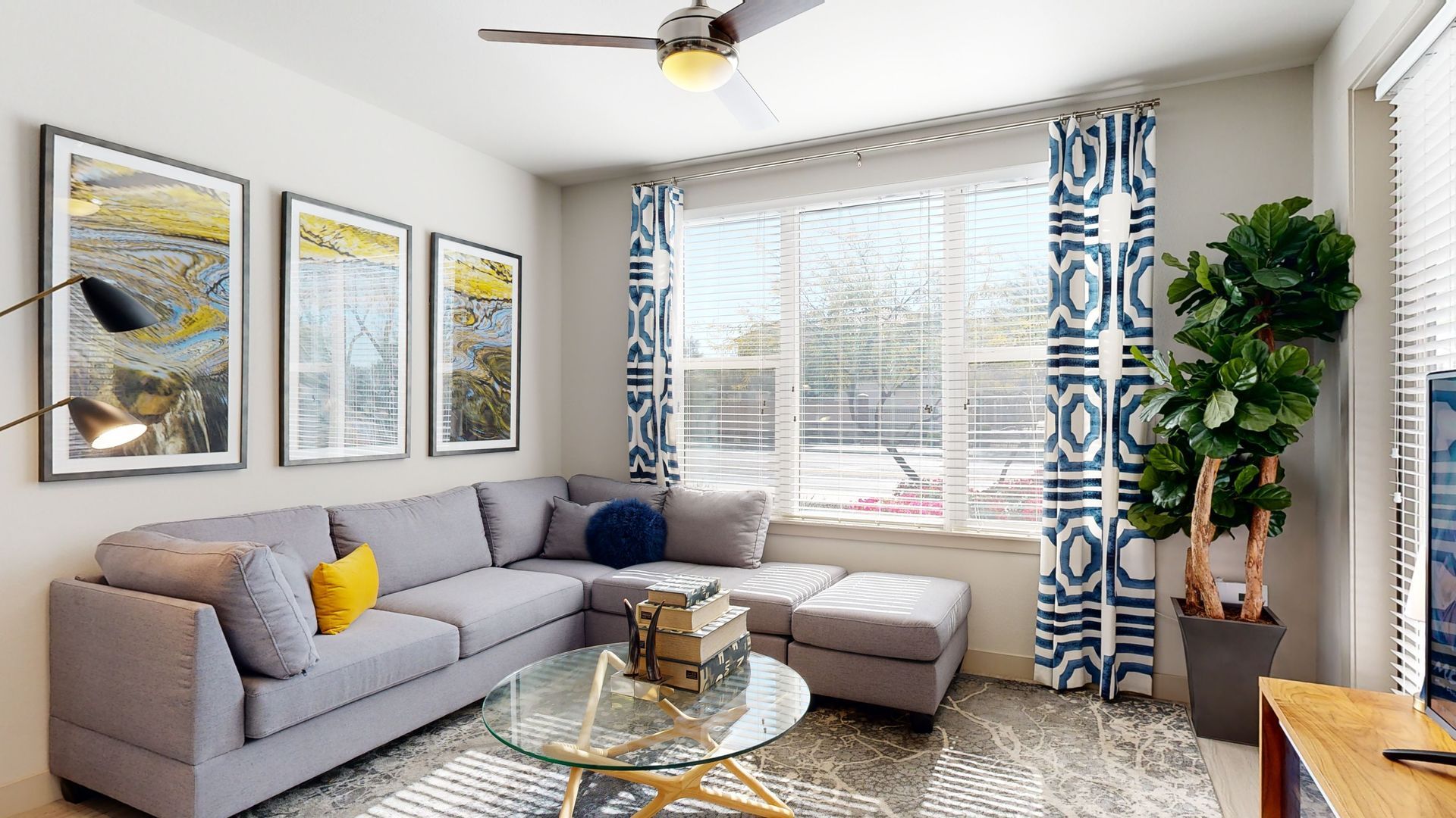 A living room with a couch , coffee table , and television.