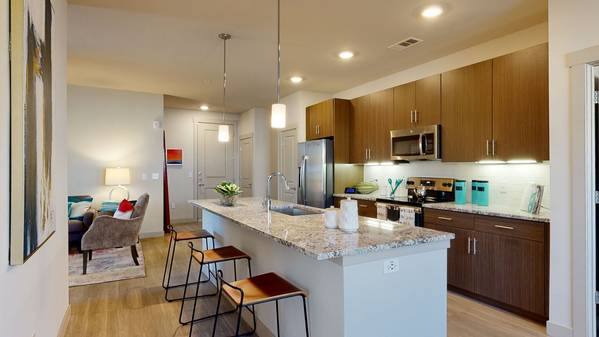 A 3d model of a kitchen with a large island and stools.
