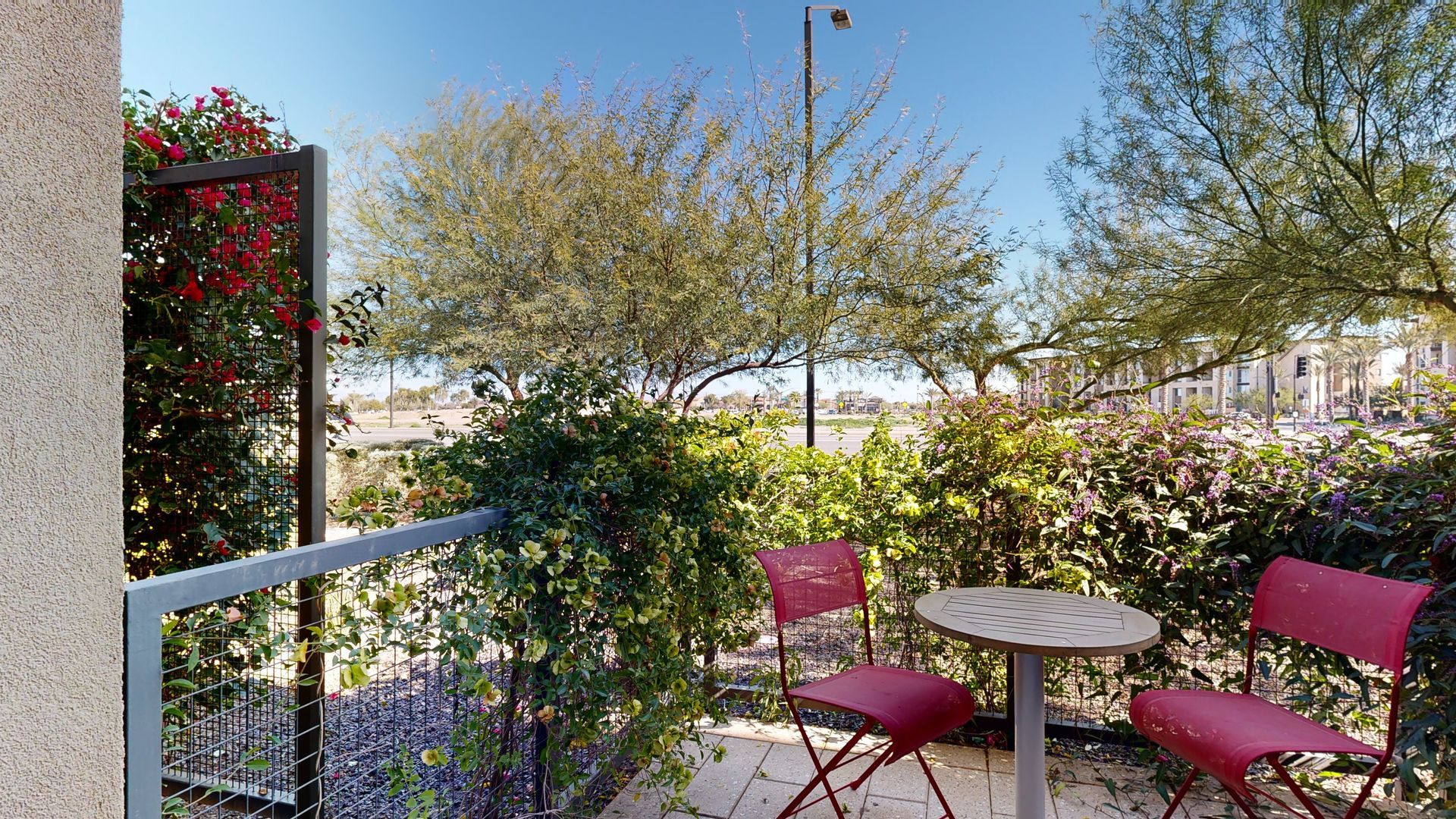 There is a table and chairs on the balcony.