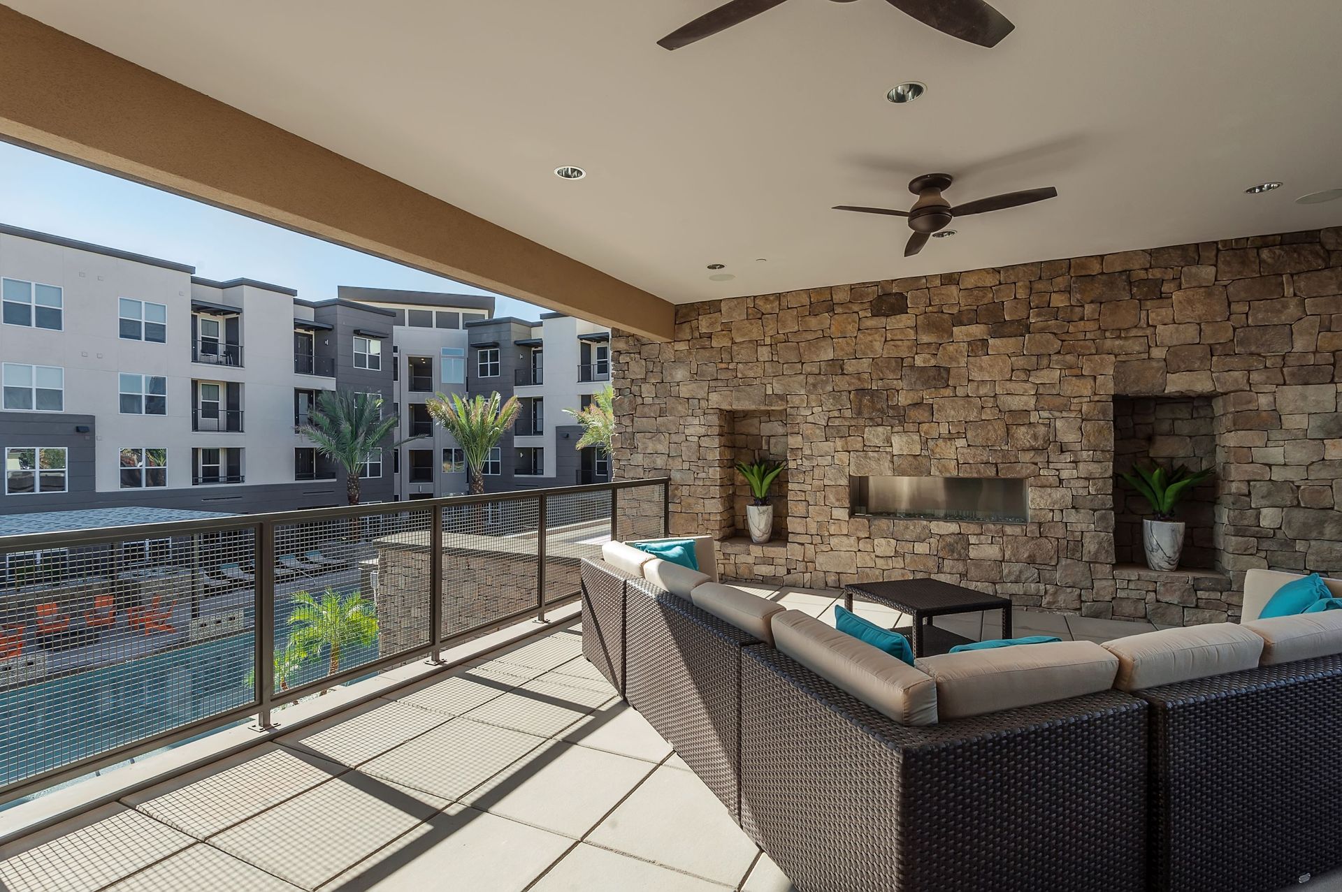 A balcony with a couch and a ceiling fan