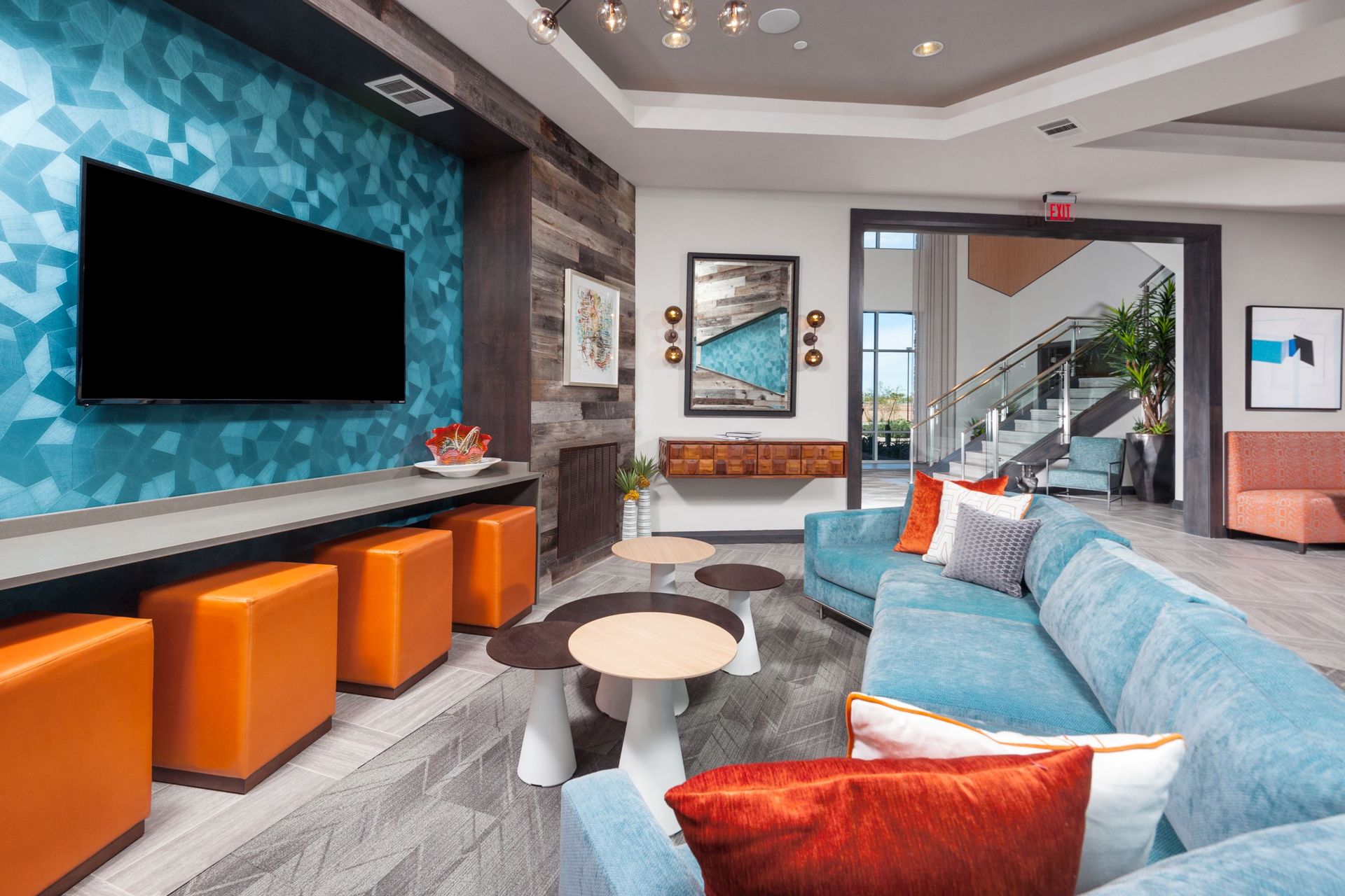 A living room with a blue couch and a flat screen tv.