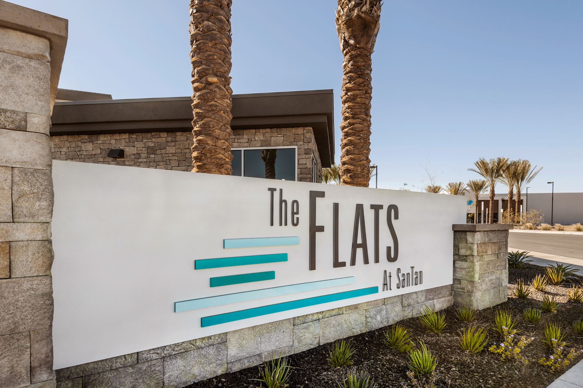 A white sign that says the flats on it