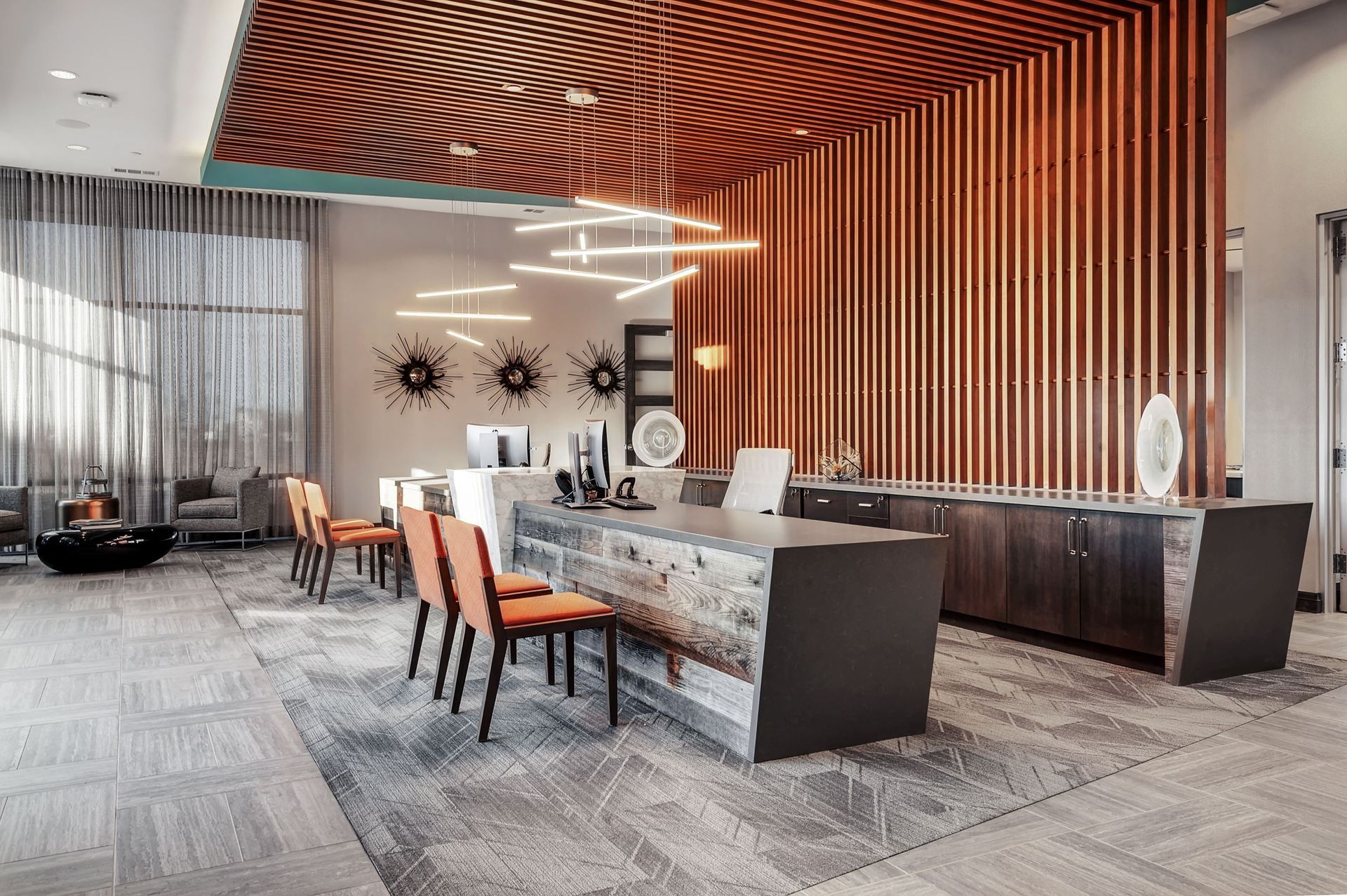 An artist 's impression of a hotel lobby with a counter and chairs.