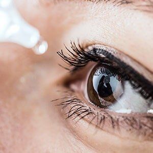 Vision — Woman Using Eye Drops in Georgia, VT