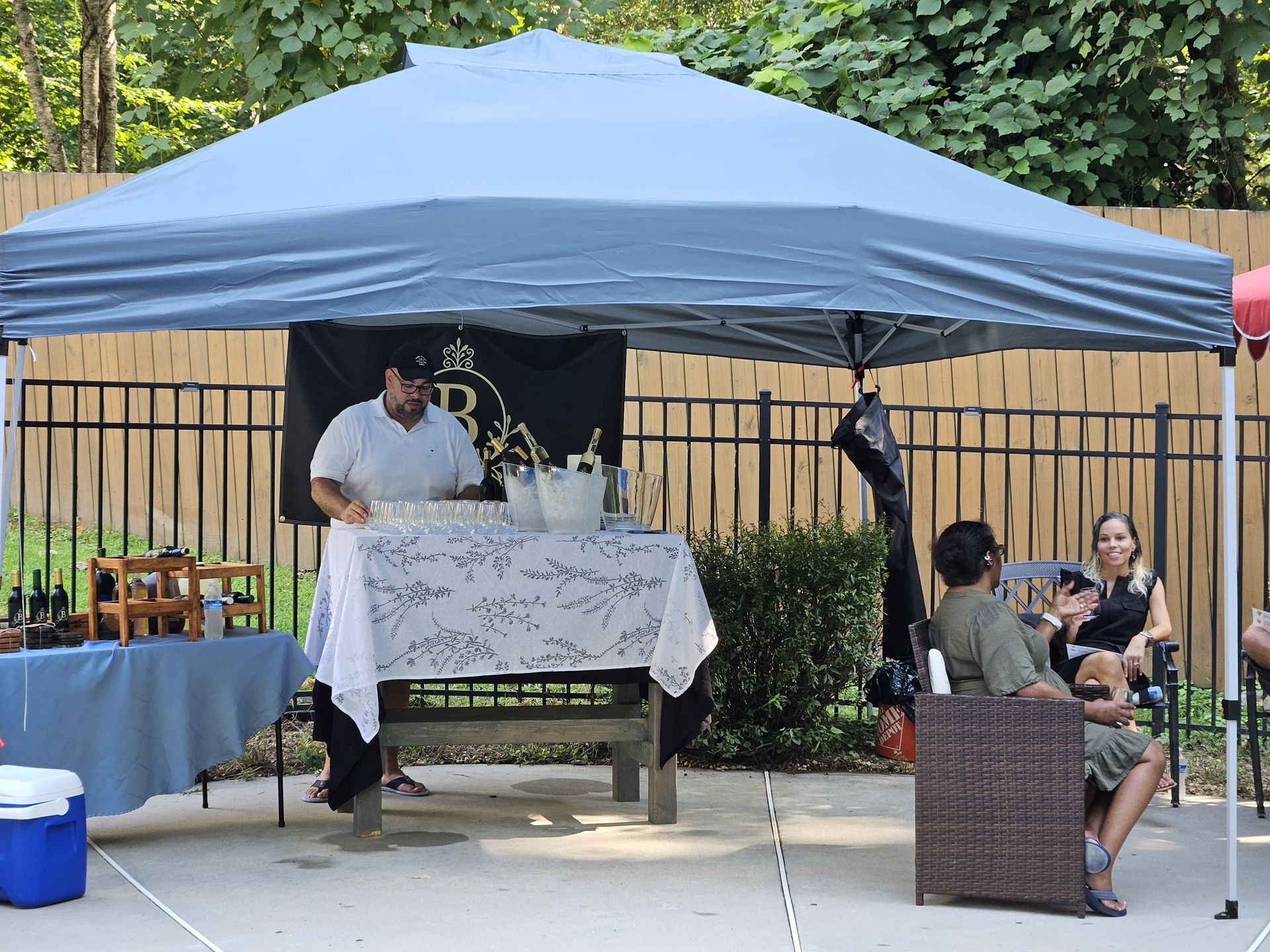 Black marble-look circle with gold accents, including a decorative floral wreath around a central circle.