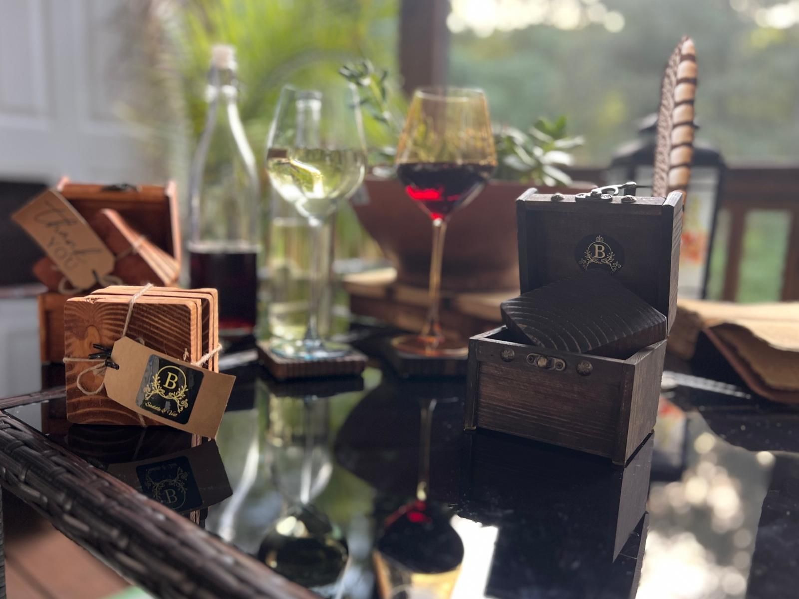 Black marble-look circle with gold accents, including a decorative floral wreath around a central circle.