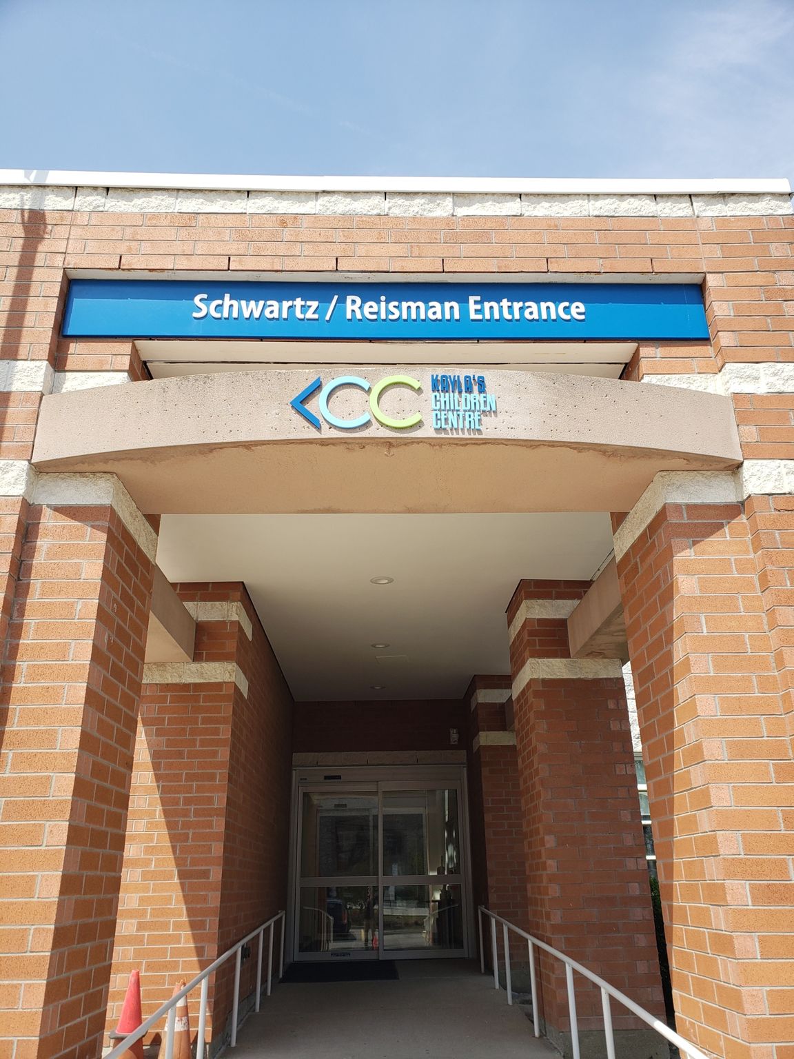a brick building with a blue sign above the entrance .