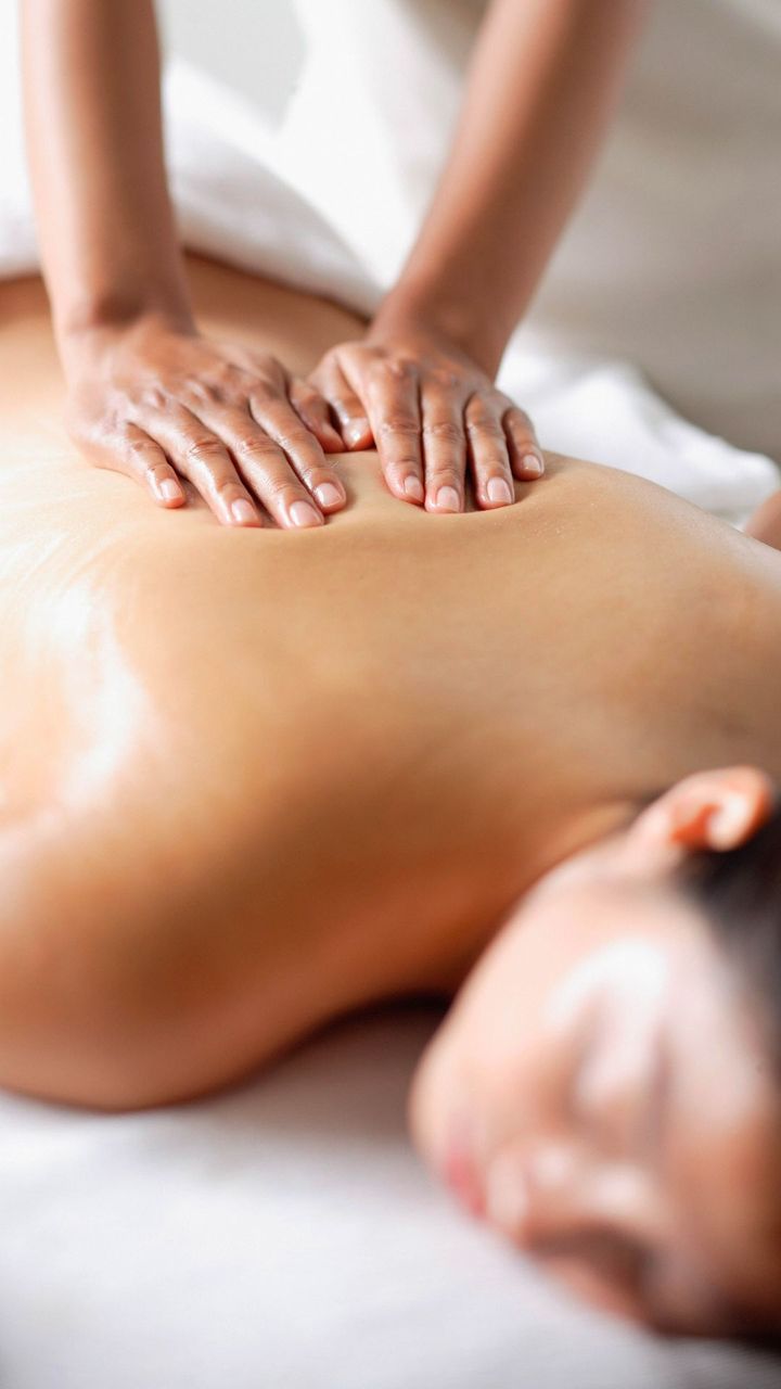 A woman is getting a massage on her back at a spa. Back Peels