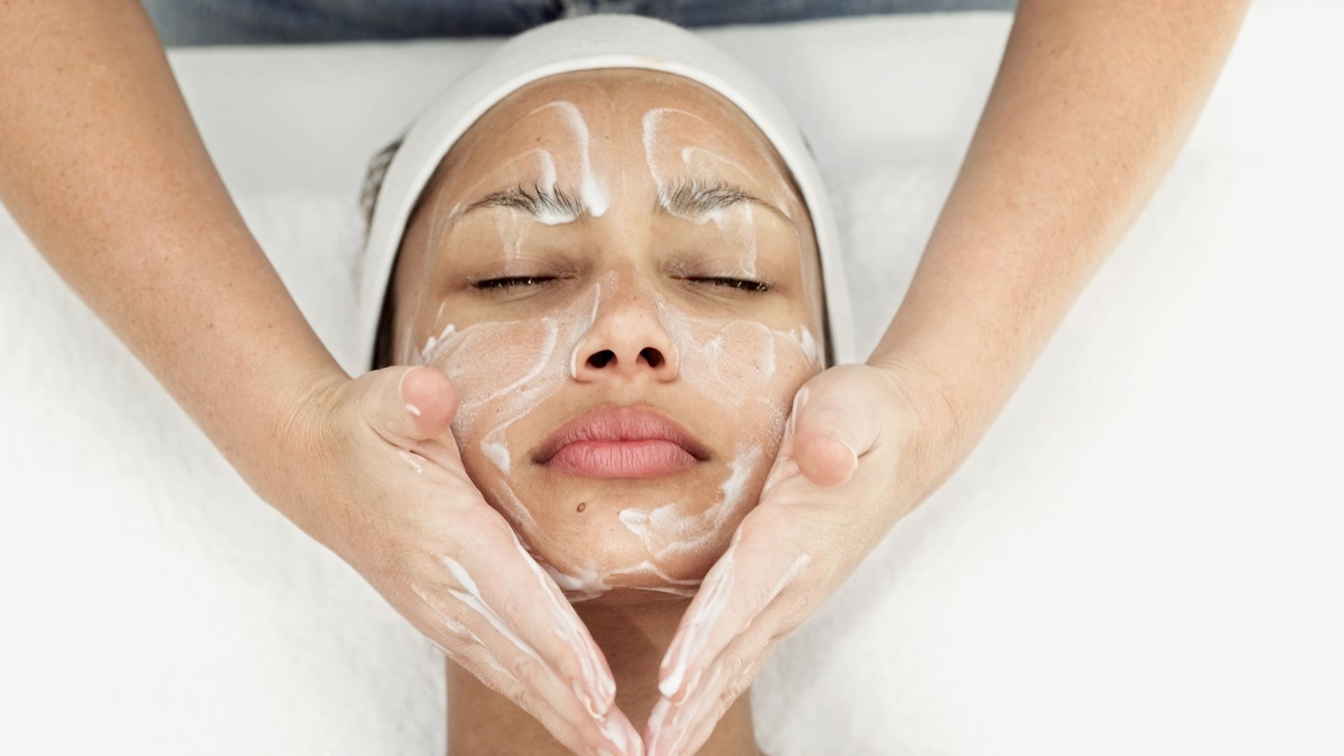 A woman is getting a facial treatment at a spa.