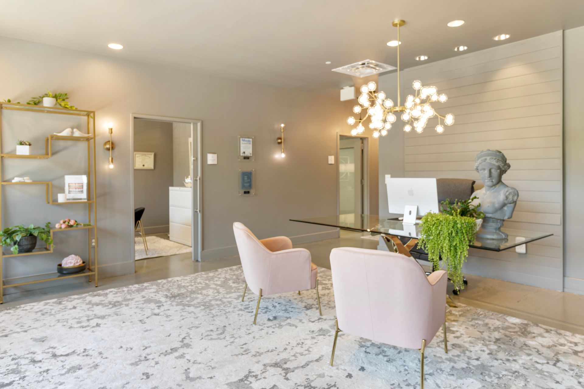 A living room with two pink chairs and a desk. Office Tour