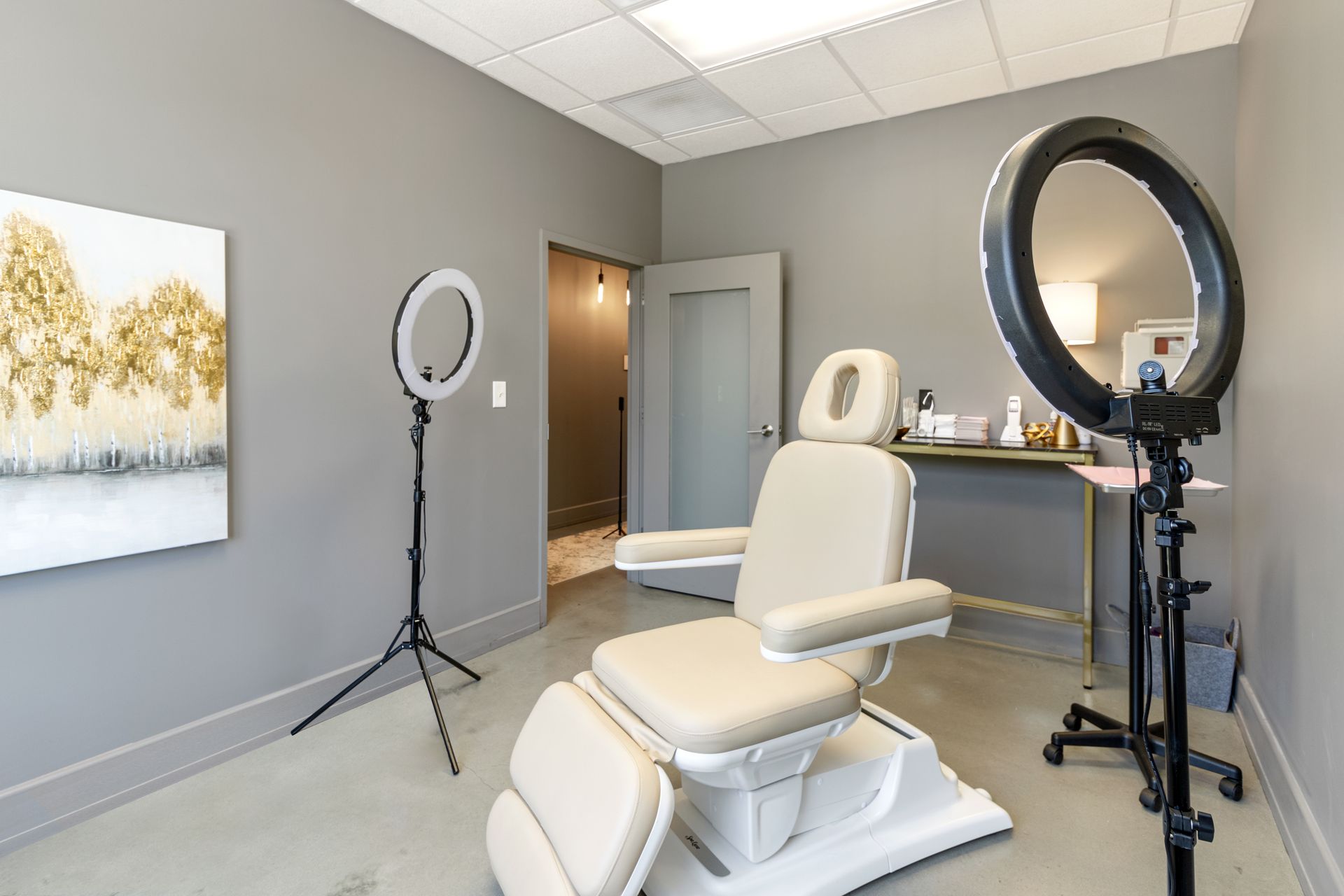 There is a chair and a ring light in the room. Office Tour