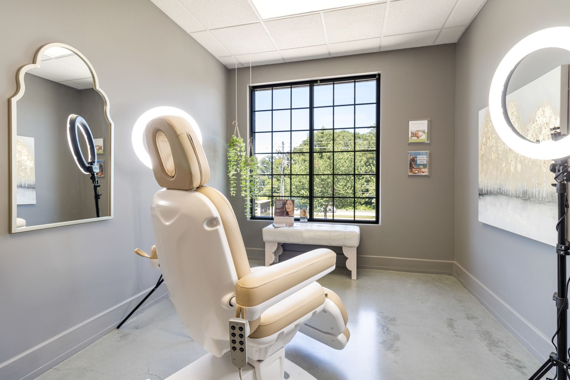 A room with a chair, mirror, and ring lights. office tour