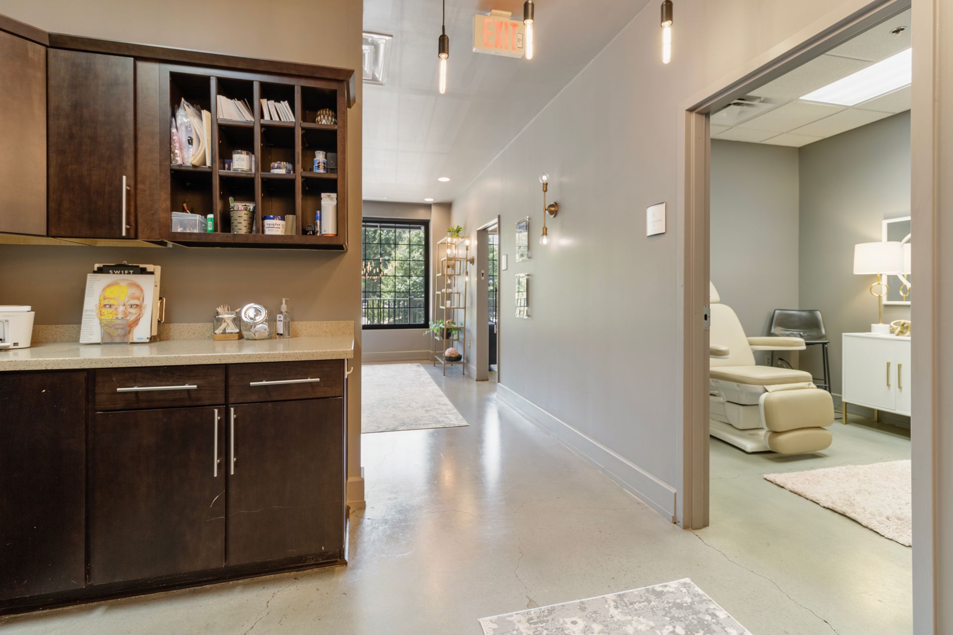 A kitchen with a sink, cabinets , and a chair. office tour