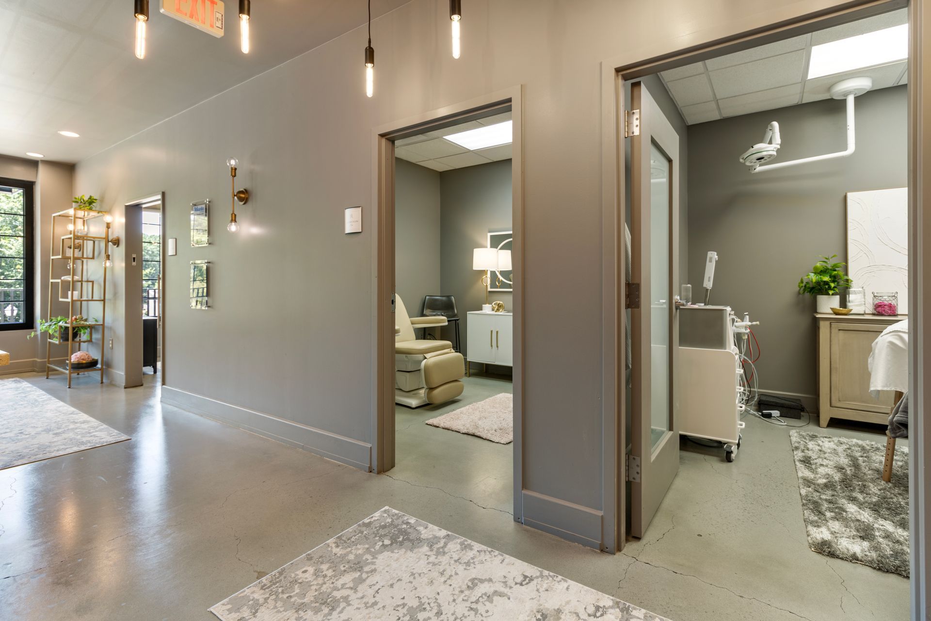 A hallway leads to a room with a chair in it. office tour