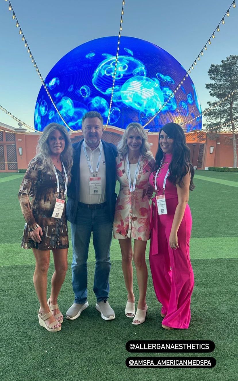A group of people are posing for a picture on a field.