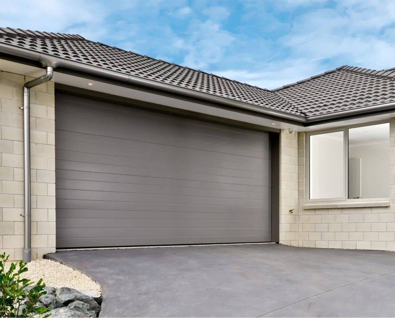 A house with a large garage door and a window.