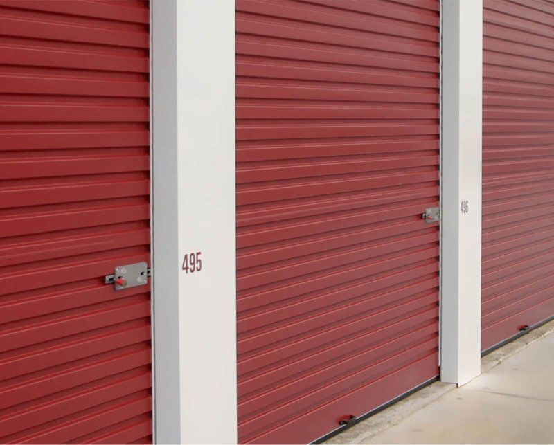 A row of red garage doors with the number 435 on them.