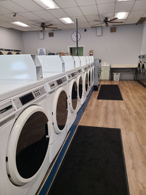 A laundromat with a lot of washers and dryers