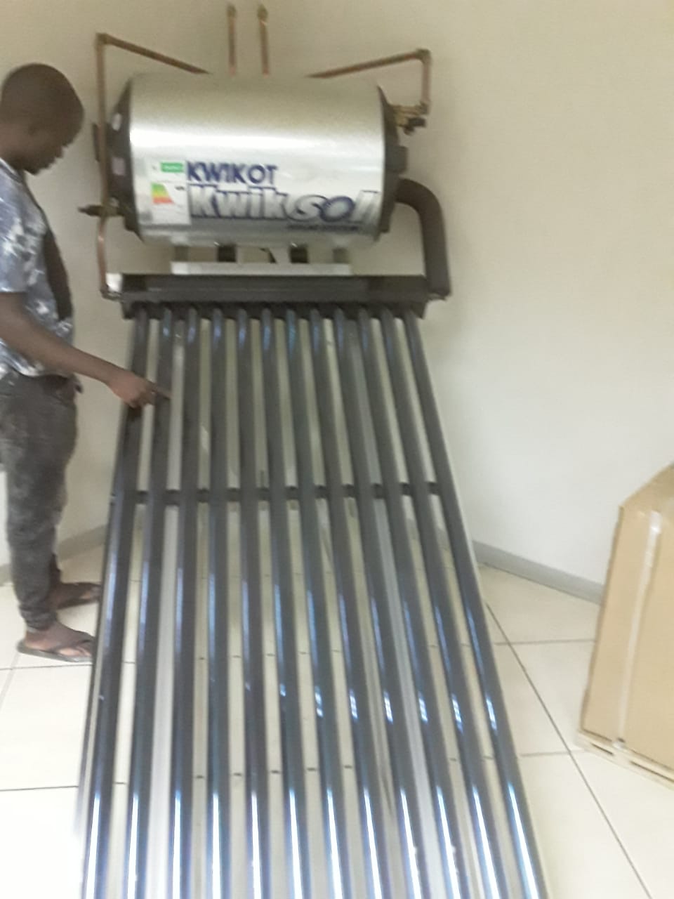 Plumbers installing a new solar geyser