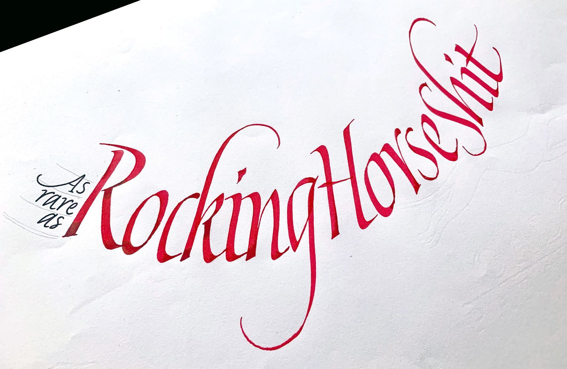 Calligraphic red script on a white background reads