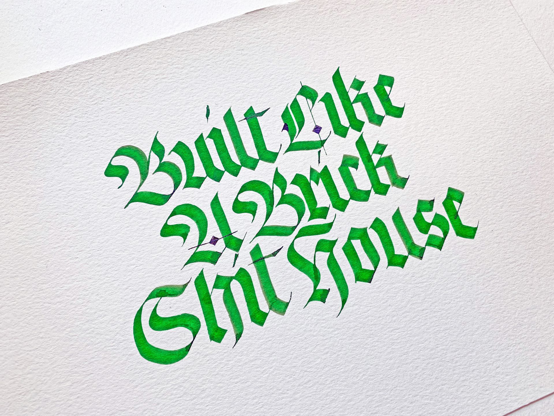 Calligraphy written in bright green ink on white paper, reading