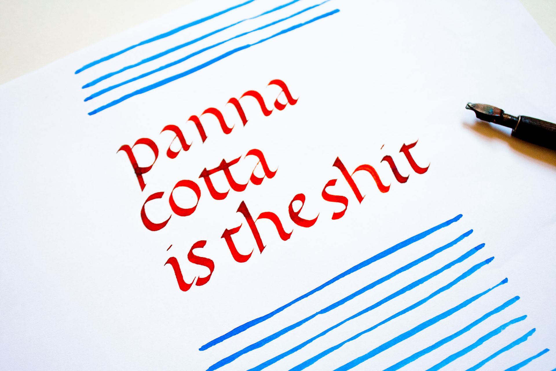 Calligraphy in red ink on white paper reads