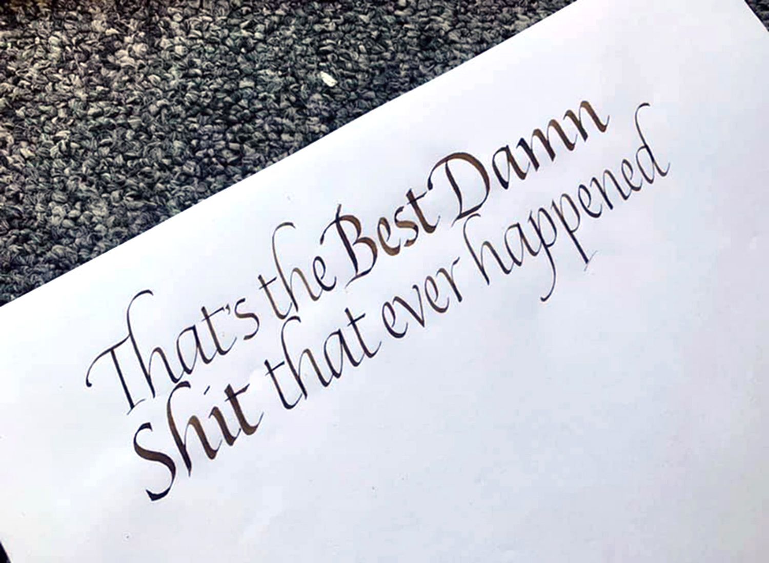 Elegant black calligraphy on white paper reads: