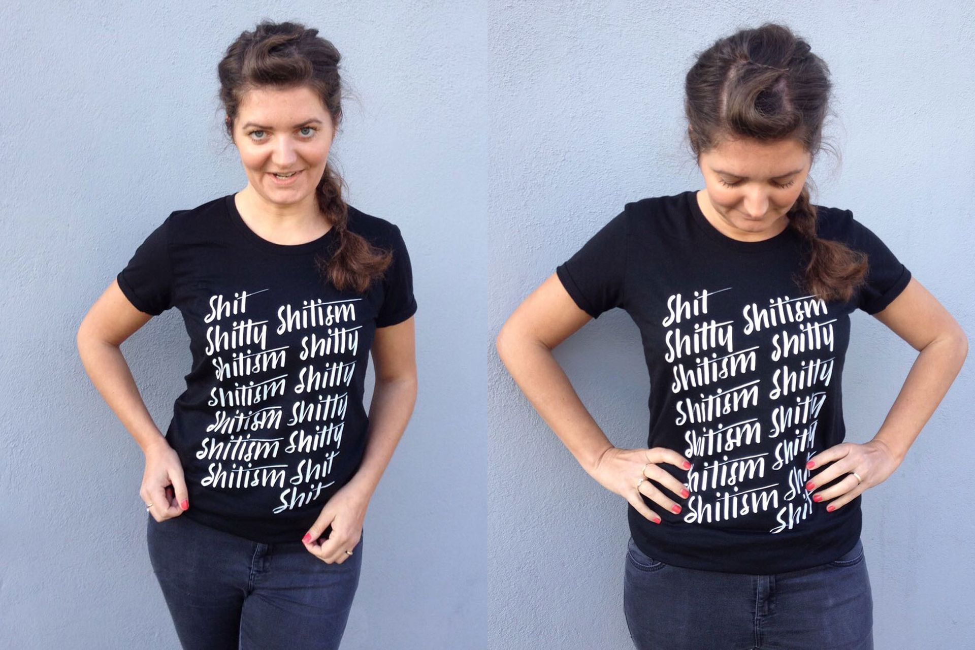 A person posing against a gray wall wearing a black t-shirt printed with repeated white text reading