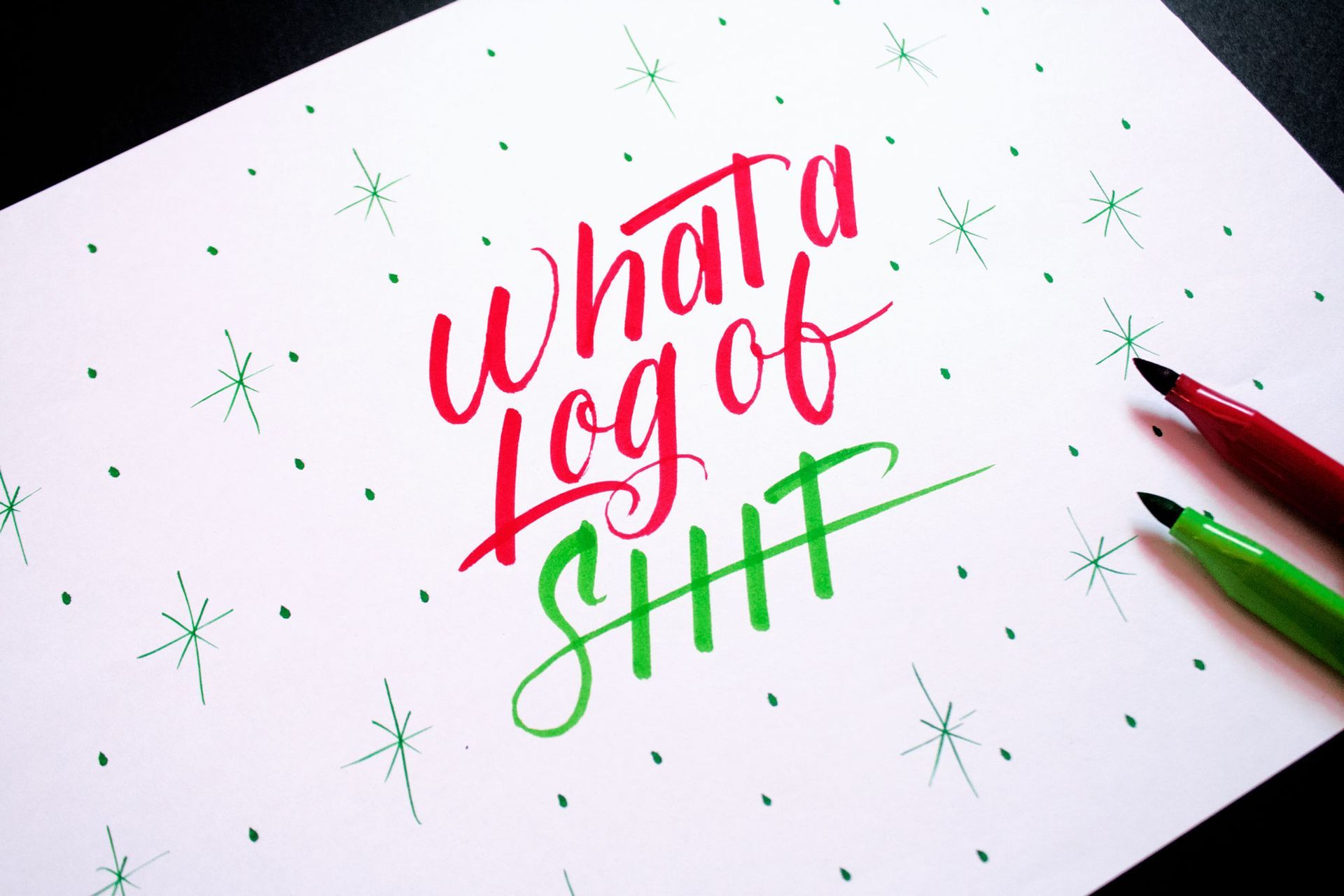 Handwritten calligraphy in red and green ink reads
