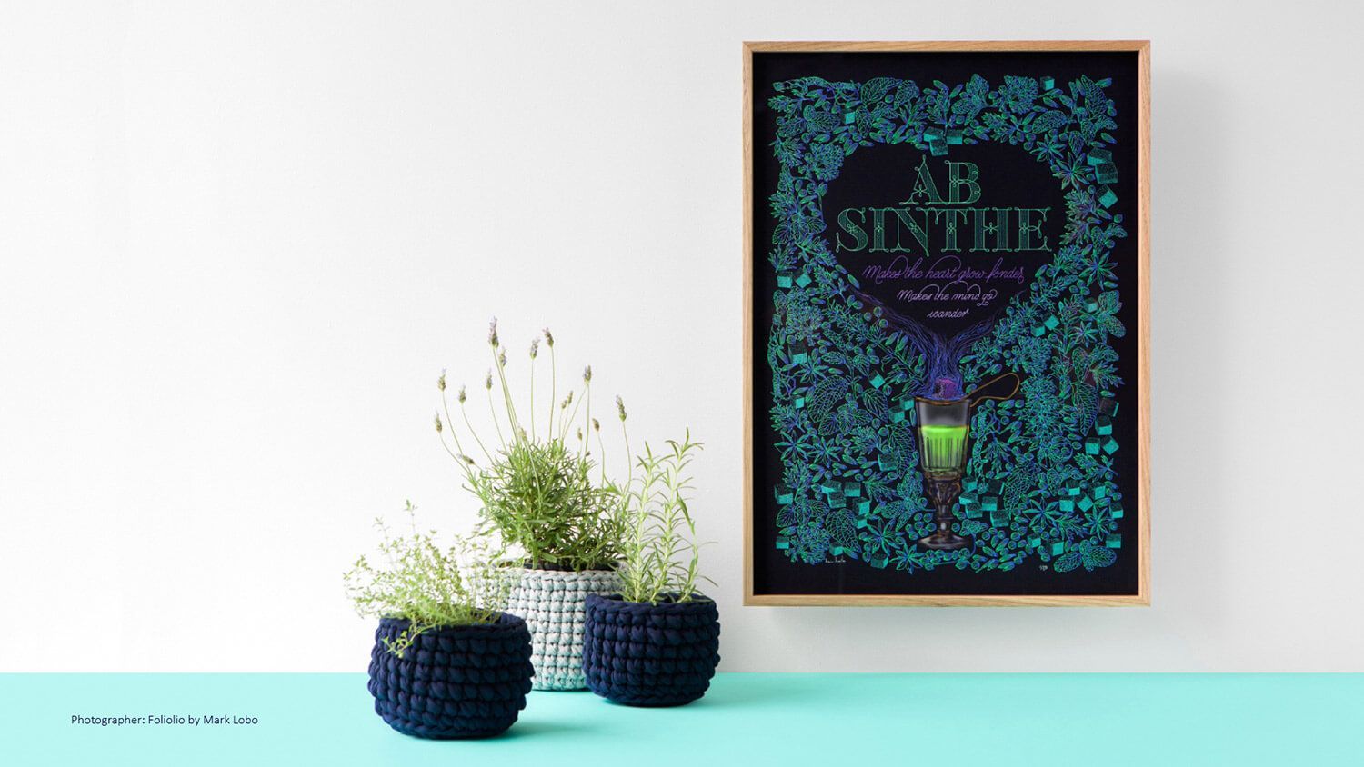 Framed neon-style wall art above two blue woven planters with greenery on a light wall