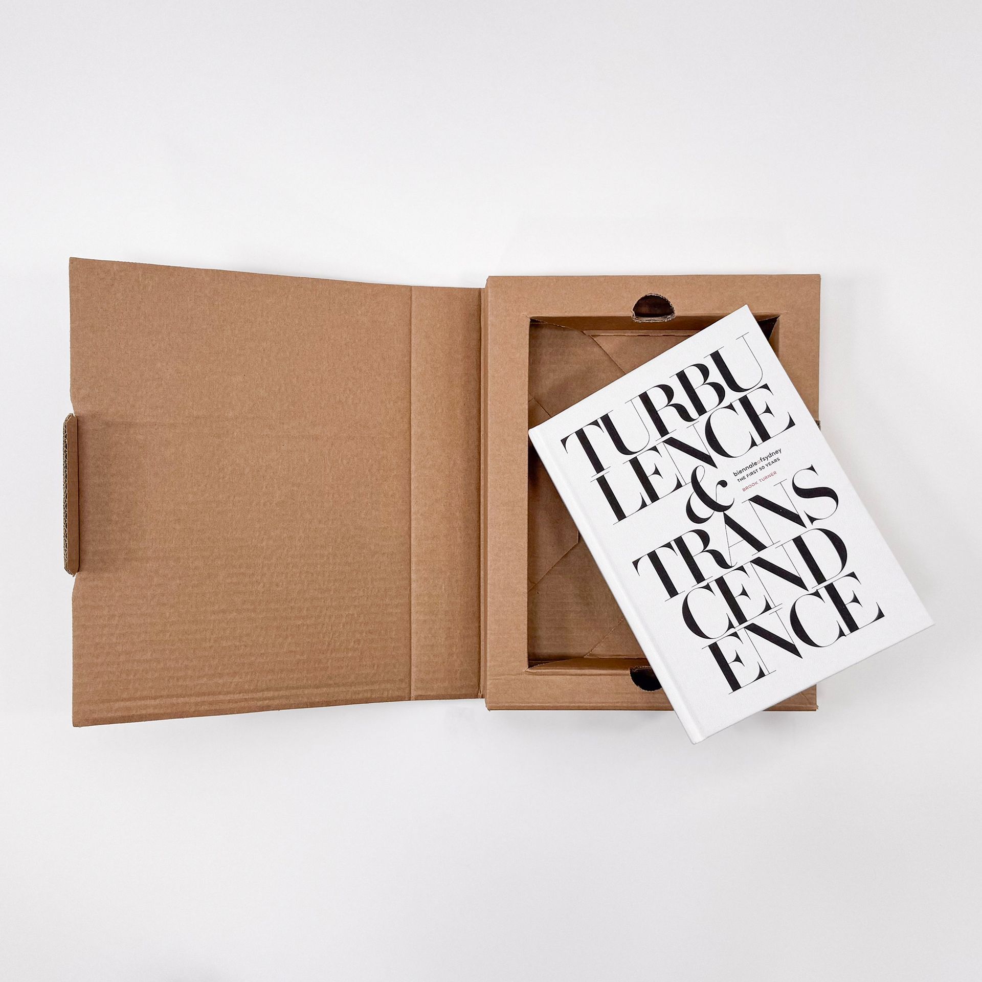 Open cardboard gift box with a black-and-white typography card inside on a white background