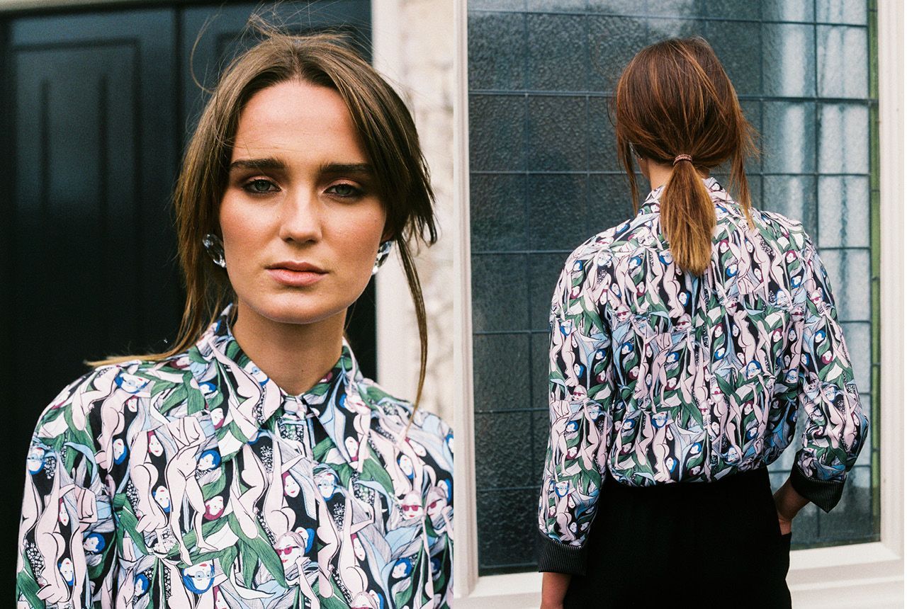 Woman in floral blouse shown front and back against a windowed urban wall