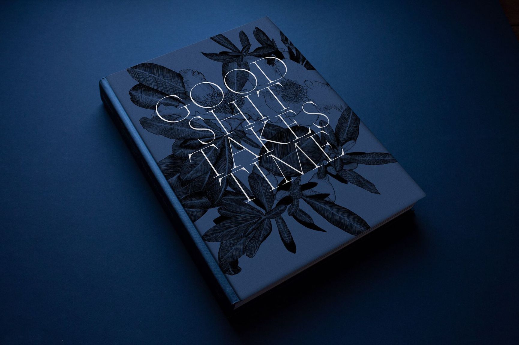 Dark blue notebook with a cracked glass cover and white floral design on a blue background