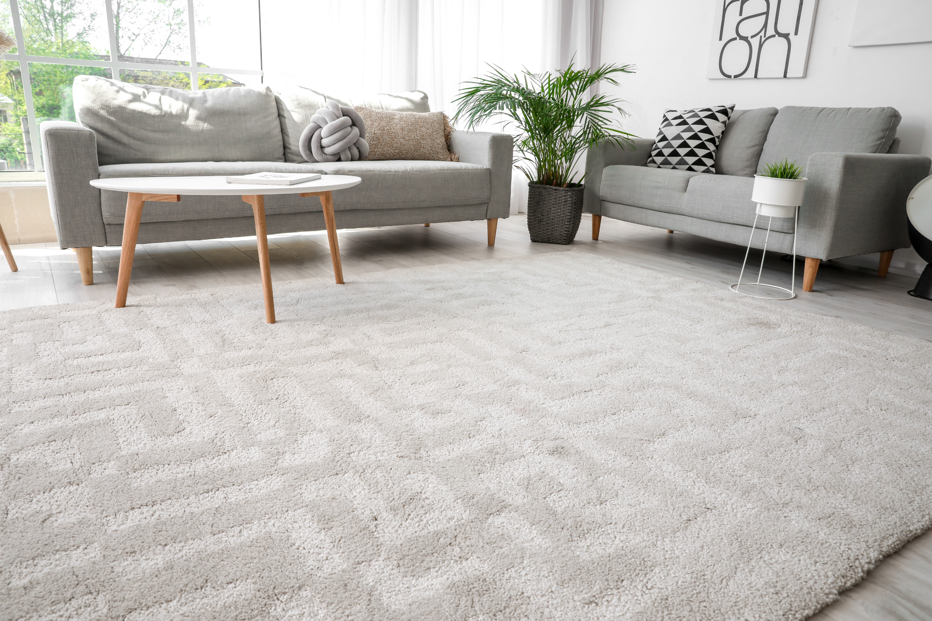 A living room with a couch , table , and a cleaned rug.