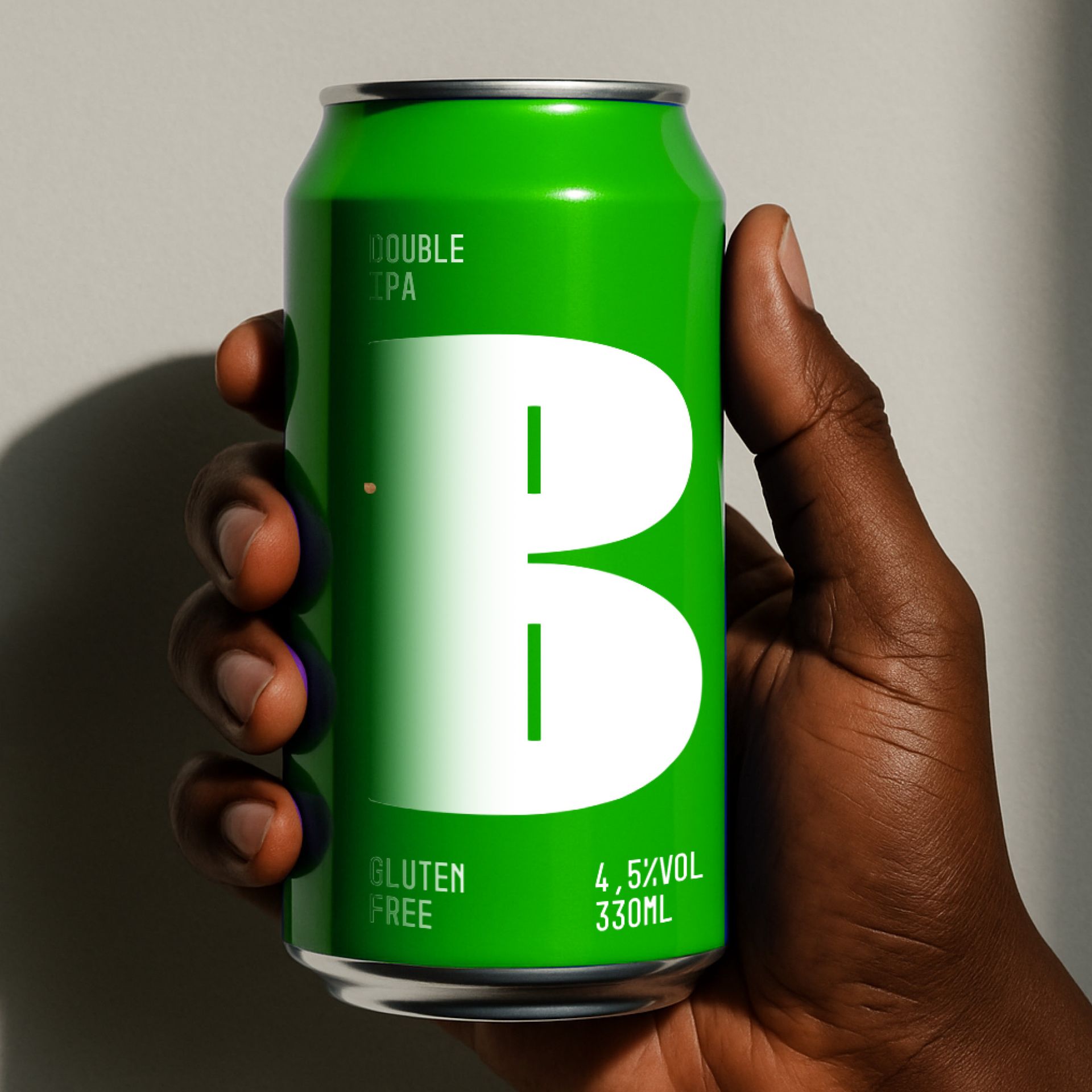 Hand holding a bright green beverage can with a large white “B” on it