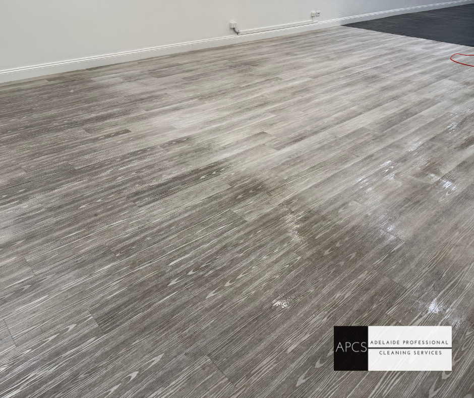 A room with a Vinyl floor and a white wall.