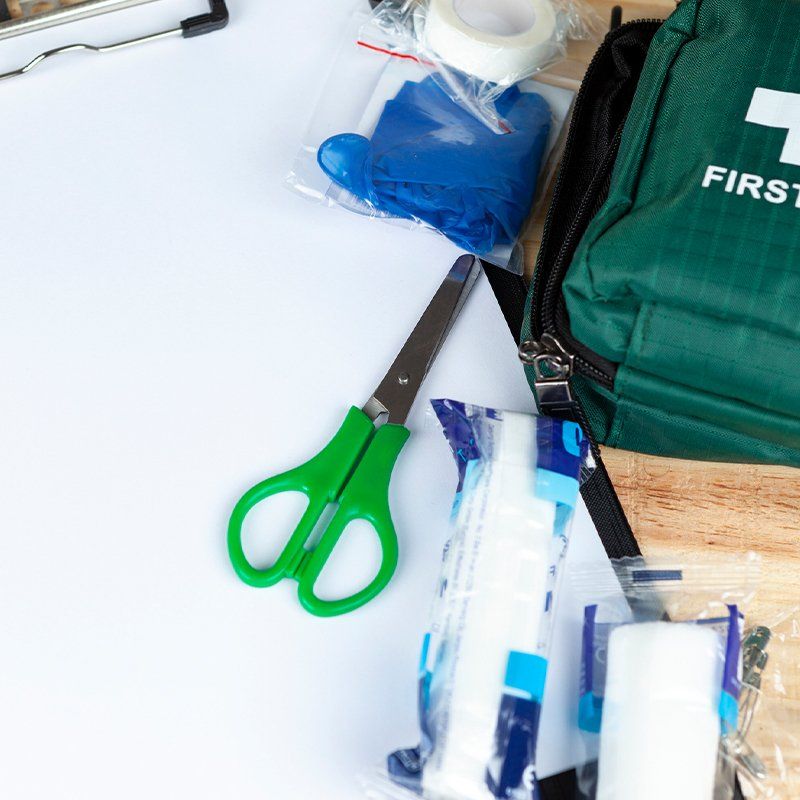 Green First Aid Kit on a Table with a Clipboard — Newcastle, NSW — JAB Safety Pty Ltd