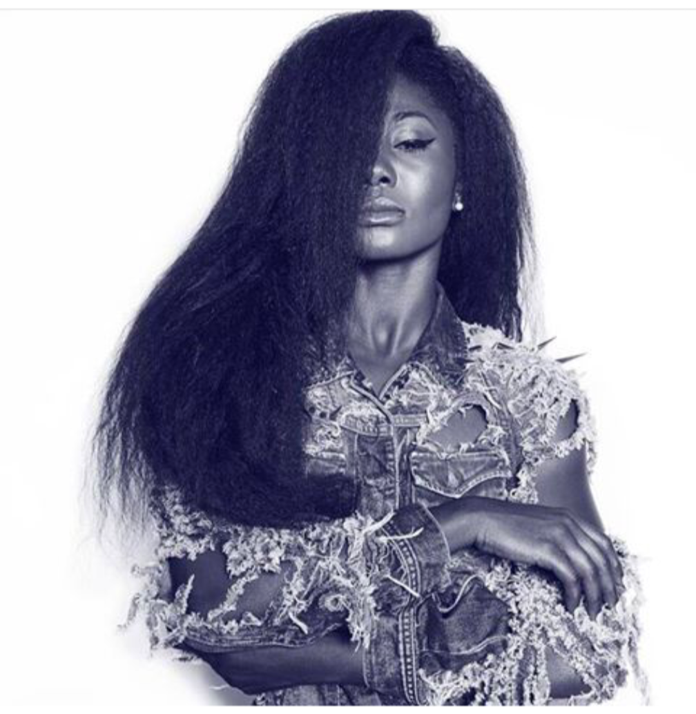 A black and white photo of a woman with long hair